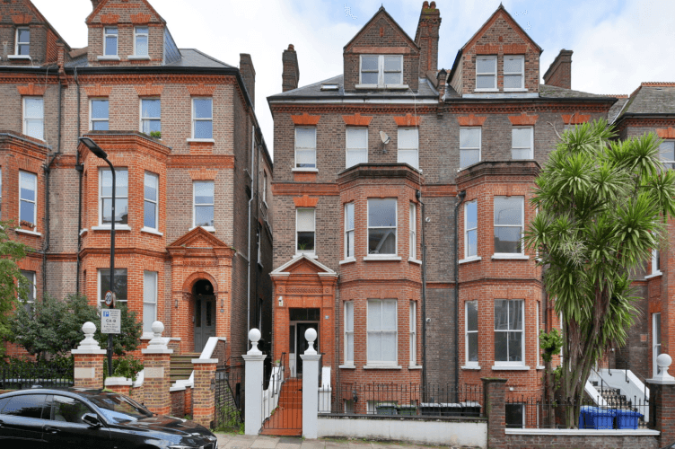 Exterior of a red brick Victorian terraced property across multiple storeys